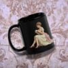 Paquete de imágenes de clipart de mujeres victorianas 10 Una taza negra con la ilustración de una mujer con un vestido vintage sentada y sosteniendo una taza de té. El fondo es un patrón texturizado y ornamentado en tonos beige y marrón.