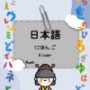 La portada de un libro de jardín de infantes en japonés titulado "Cuaderno de Trabajo (Preescolar) Japonés" presenta coloridos caracteres hiragana alrededor de los bordes. Un cuadrado gris en el centro contiene "日本語" (japonés) y "にほんご Kinder". En la parte inferior, un simpático personaje viste un traje tradicional japonés.