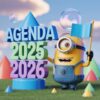 Un alegre Minion sostiene una bandera azul junto a un colorido texto en 3D en el que se lee "AGENDA 2025 2026" sobre un campo cubierto de hierba con formas geométricas y burbujas flotantes de fondo.