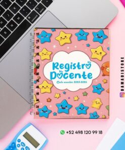 Un colorido cuaderno de notas del profesor, con estrellas y nubes de dibujos animados en la portada, reposa sobre un escritorio junto a una laptop, una calculadora azul y bolígrafos rosas. La portada dice 