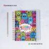 Una colorida agenda docente con simpáticos monstruos de dibujos animados en la portada, titulada "Agenda Docente 2015-2016". Junto a ella hay un bolígrafo y la información de contacto aparece sobre un fondo blanco.