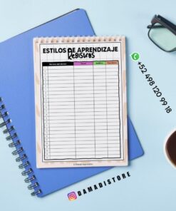 Un bloc de notas con un gráfico de registro de estilos de aprendizaje descansa sobre un cuaderno azul. En la imagen se ven unas gafas, una taza de café, un bolígrafo, un número de WhatsApp y la cuenta de Instagram @damadistore.