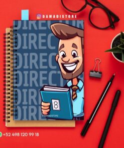 Encima de un cuaderno de espiral hay un cuaderno de dibujos animados con un hombre sonriente con corbata que sostiene un libro. A su alrededor hay unas gafas, un bolígrafo, un lápiz, un clip de carpeta, una pequeña maceta y un número de contacto de WhatsApp.